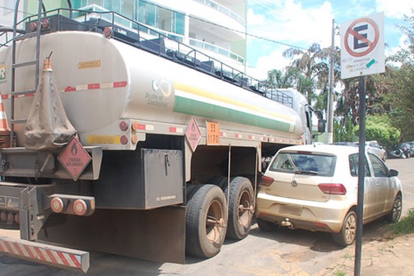 Caminhão de combustível tenta conversão no centro e atinge carro estacionado em local proibido