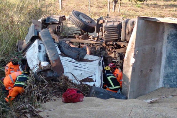 Carreta carregada com soja tomba na MGC 354 e motorista fica preso às ferragens